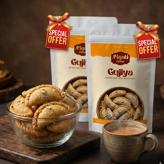 Packages of Gujiya with a bowl of gujiya and a cup of tea on a wooden surface.
